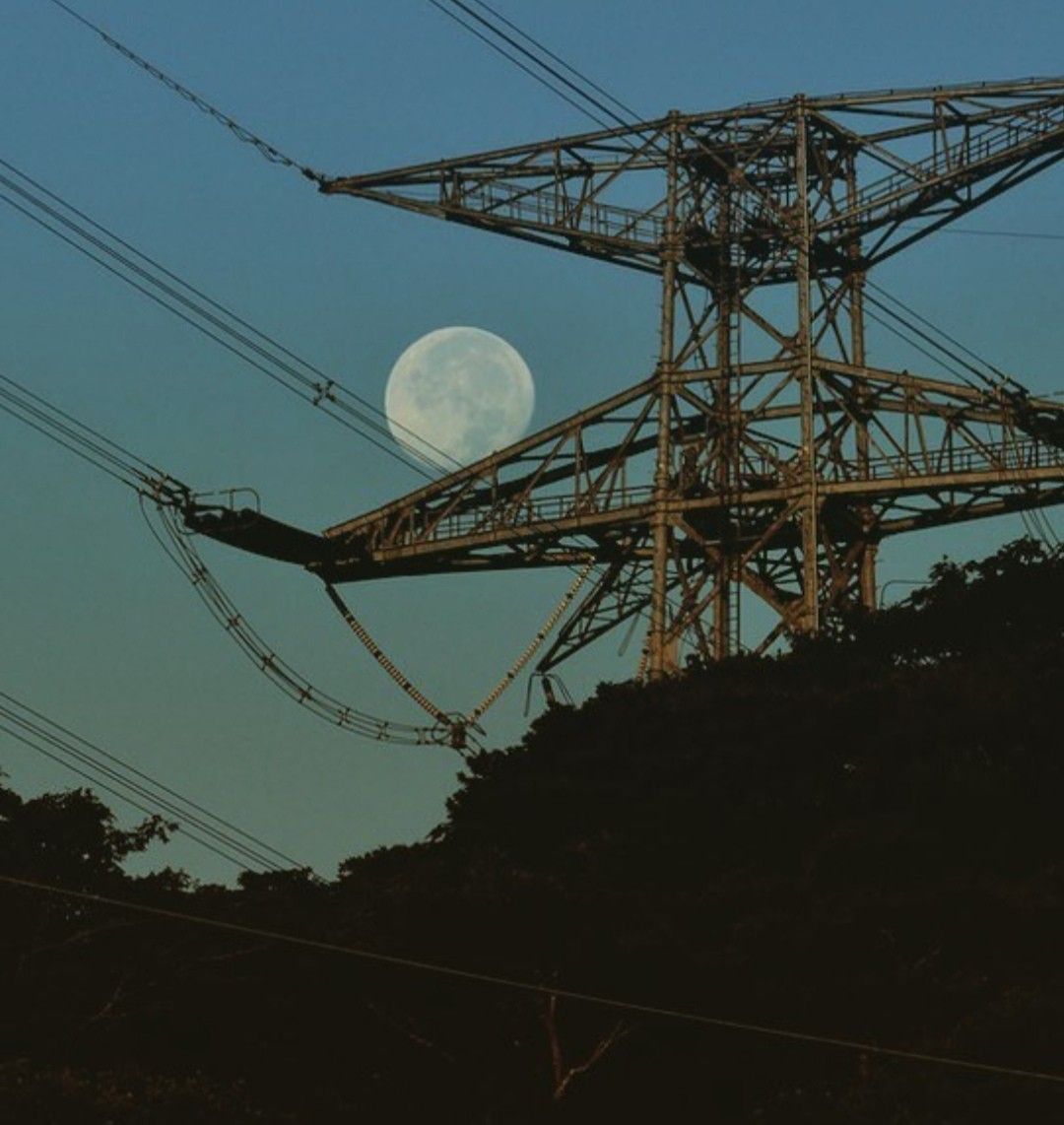 the moon between the powerlines